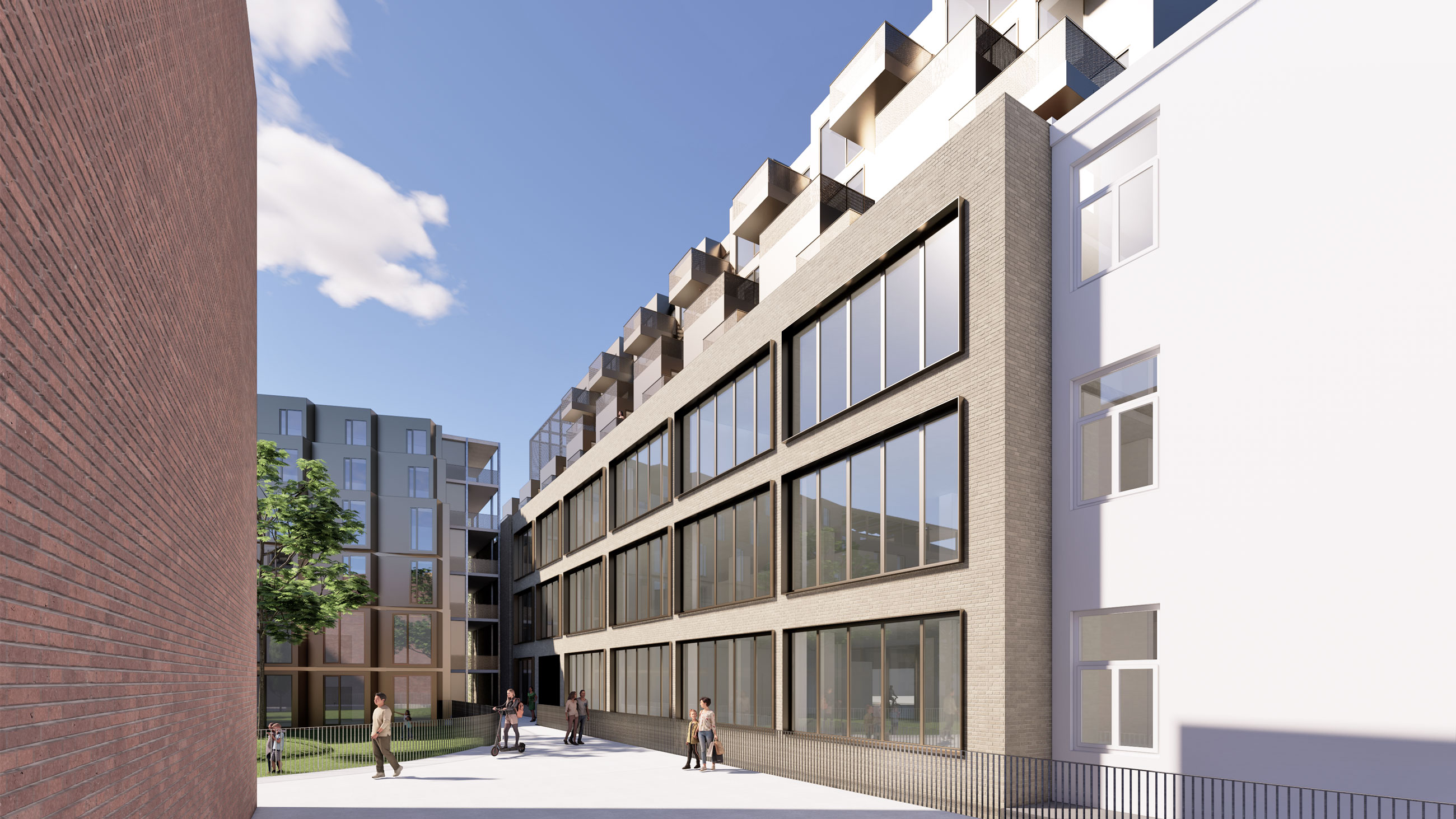 Modern brick-and-glass office building with a paved courtyard; several pedestrians walk near a tree under a blue sky.