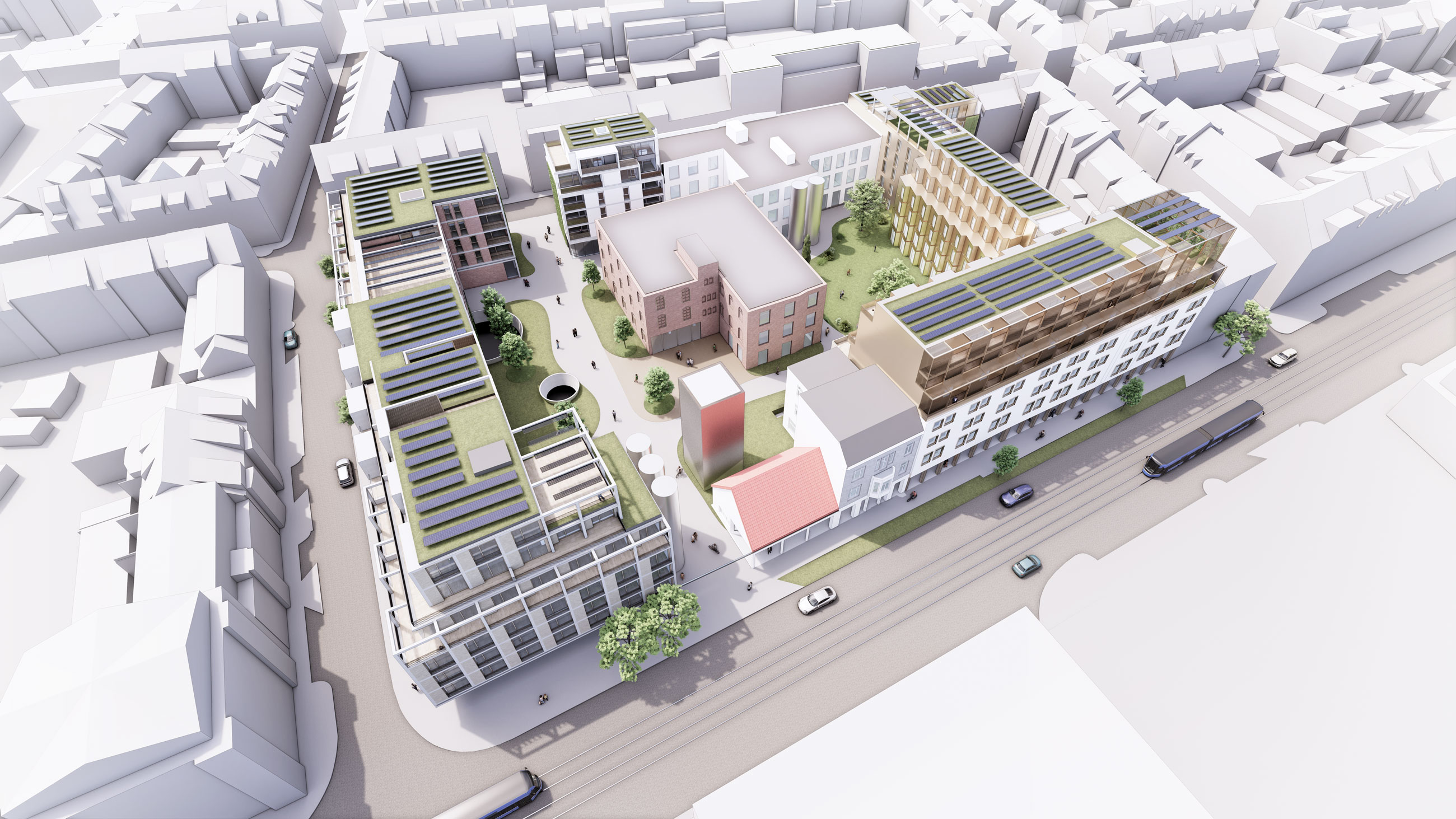 Aerial view of a modern urban development with interconnected mixed-use buildings, green rooftops, solar panels, and a central courtyard.