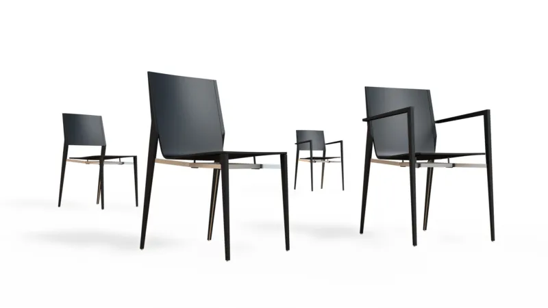 Five modern navy-blue upholstered chairs with slender metal legs, arranged in a white studio.